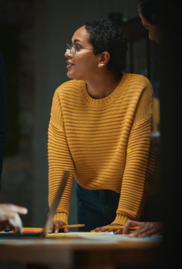 Diverse-Multiethnic-Team-are-Having-a-Conversation-in-a-Meeting-Room-Behind-Glass-Walls-in-a-Creative-Office Diverse-Multiethnic-Team-are-Having-a-Conversation-in-a-Meeting-Room-Behind-Glass-Walls-in-a-Creative-Office